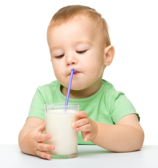 baby drinking milk from a straw