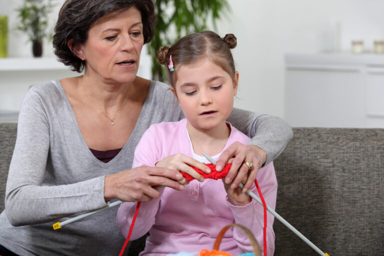 woman teaching a child to knit