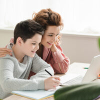 mother and son homeschooling together