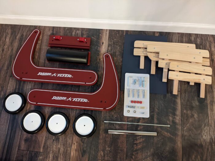 Radio Flyer Wagon disassembled with all parts on the floor.