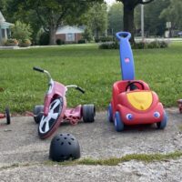 our collection of ride-on toys in the driveway