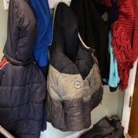 children winter coats hanging on the coat rack