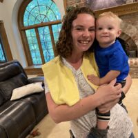 mom and baby with burp boss burp cloth over shoulders